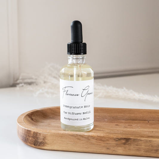 Bottle of Florence Grace diffuser oil on a wooden tray with a neutral background