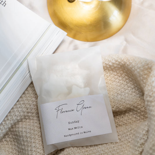 Product packaging with a label on a textured surface, illuminated by a gold lamp.